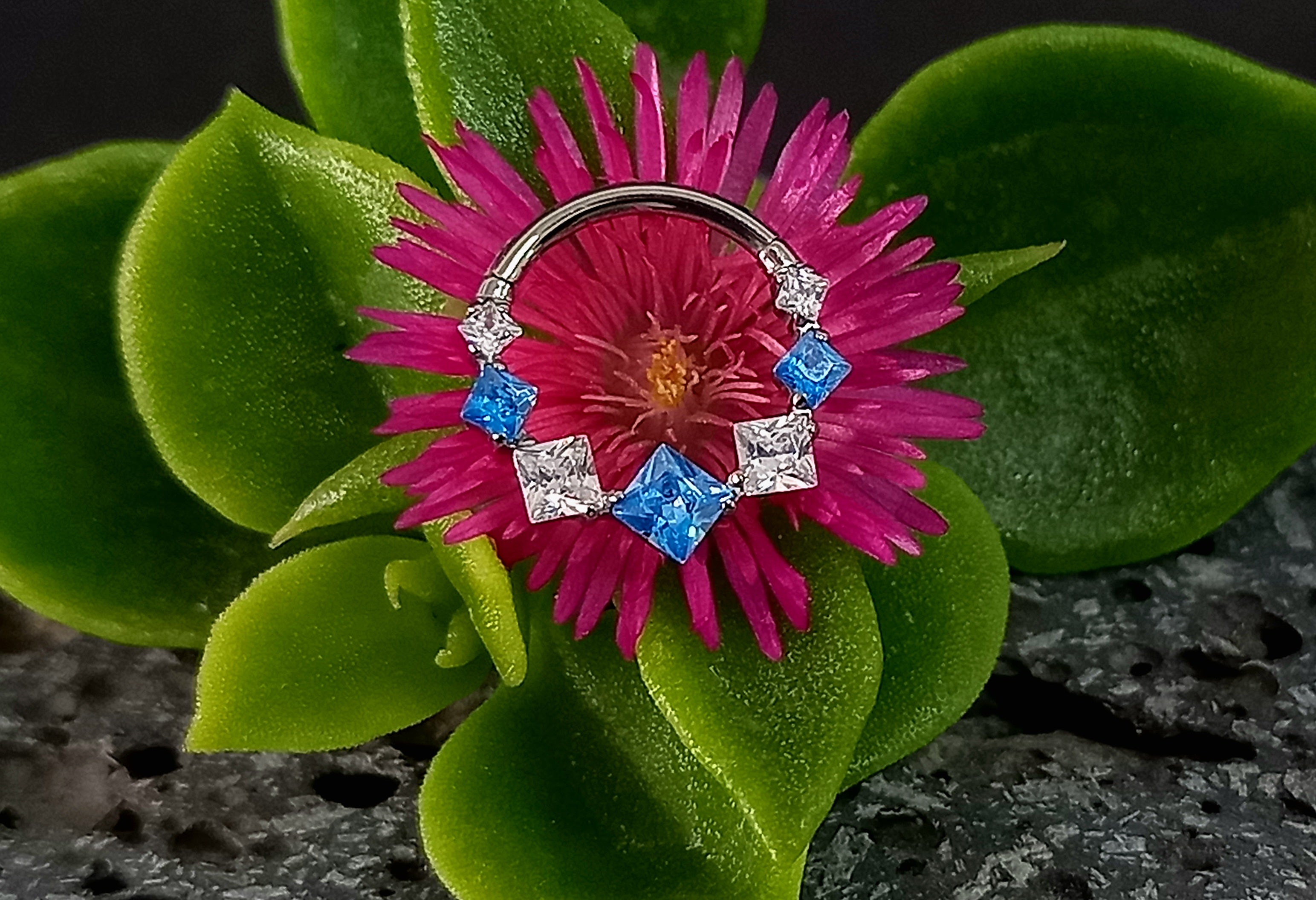 Argolla clicker zircón con rombos azul y clear